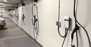 Apartment EV charging station with multiple chargers in parking lot for residents